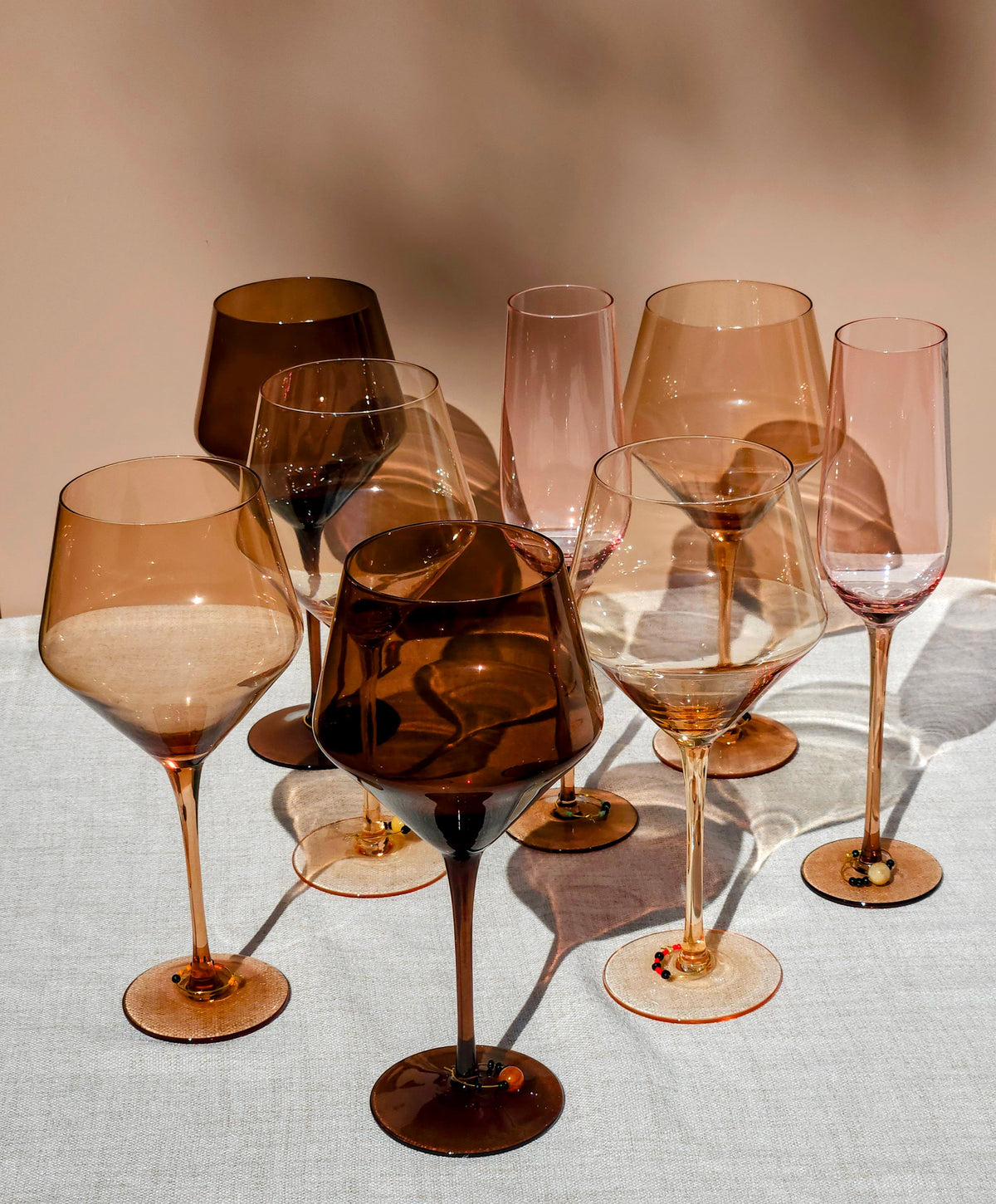 Girls Night In Bundle featuring Spectrum wine glasses, champagne flutes, and glass charms on a linen table