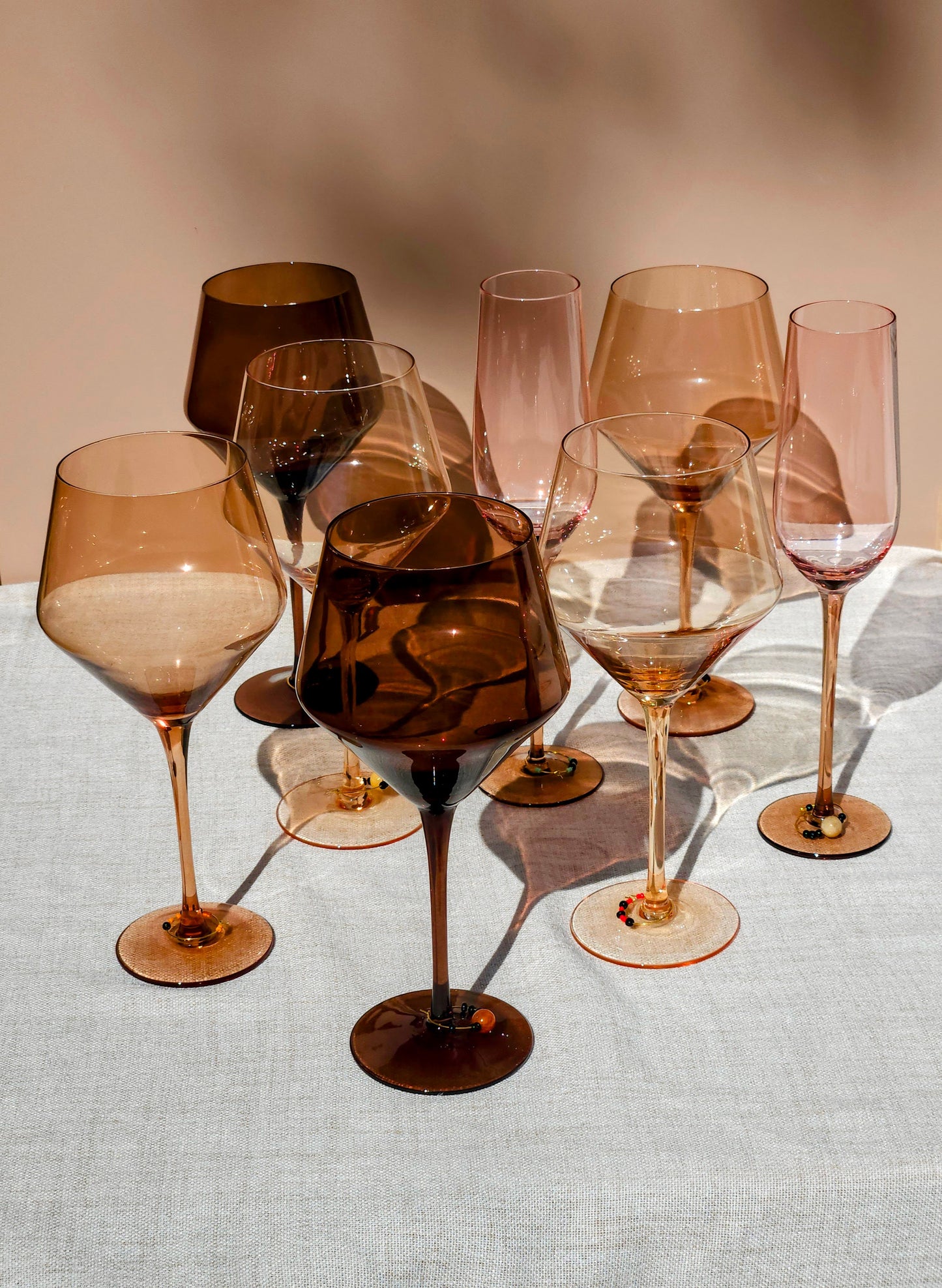 Girls Night In Bundle featuring Spectrum wine glasses, champagne flutes, and glass charms on a linen table