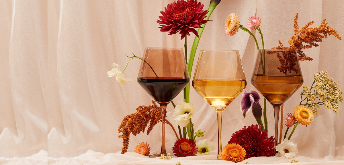 Mila, Zuzu and Kiki nude-tone wine glasses surrounded by flowers